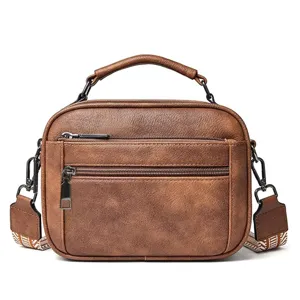 Brown PU leather crossbody bag with top handle, dual front zippers and stylish strap.