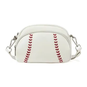 White baseball shape crossbody shoulder bag detail featuring red stitching and hardware.