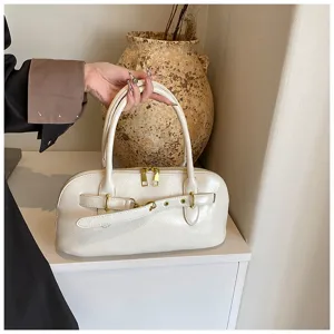 Nahaufnahme der weißen PU-Ledertasche mit goldenen Reißverschlüssen und schickem Gürtelschnallen-Detail.