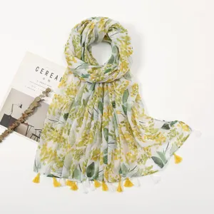 Detailed view of the botanical print cotton linen scarf with yellow tassels, lightweight summer.