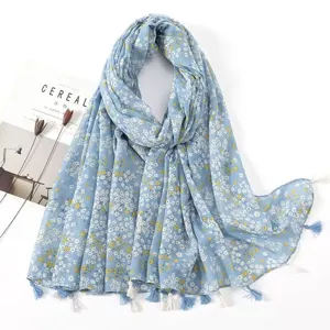 Light blue floral tassel cotton linen scarf detail, delicate print and elegant drape style.