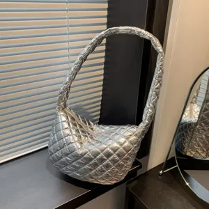 Silver quilted shoulder bag for women, stylish metallic puffer hobo handbag for daily use.