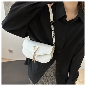 White shoulder bag with metal V logo and chain strap, stylish crossbody bag for women.