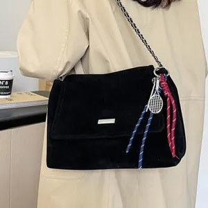 Trendy black suede shoulder bag for women with chain strap and stylish tennis charm.