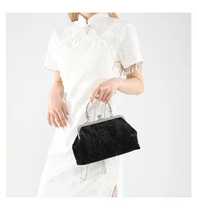 Detailed view of the vintage black velvet handbag with silver chain and metal clasp design.