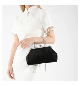 Vintage black velvet evening bag with metal lock and stylish chain strap for women.