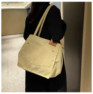 Detailed view of stylish beige corduroy tote bag, large capacity daily shoulder bag.