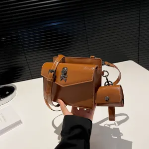 Brown PU leather small square crossbody bag with metal skull decoration and mini pouch stylish.