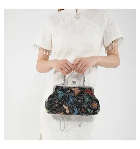 Close-up detail of the vintage Chinese style embroidered handbag with metal chain and clasp.