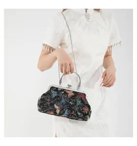 Retro Chinese embroidered butterfly shoulder bag with metallic kiss-lock and delicate chain strap.