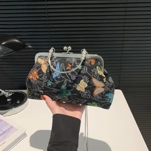 Retro Chinese style butterfly tapestry handbag with metal lock frame and elegant chain strap.