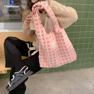 Detail shot of pink fuzzy checkered tote bag, plush waffle grid shoulder bag for daily commute.