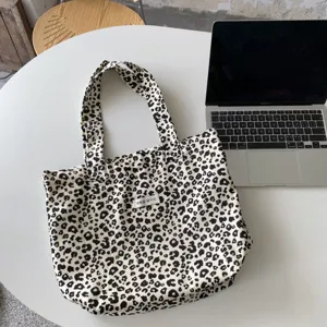 Detail shot of retro leopard print canvas tote bag, large capacity casual shoulder bag daily.