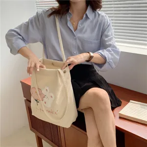 Cute Japanese corduroy shoulder bag for women with adorable rabbit embroidery and spacious interior.