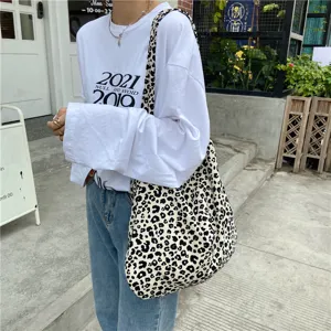 Stylish leopard print canvas shoulder bag, large capacity casual tote bag for women daily use.