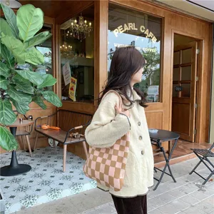 Detail shot of a stylish pink and brown checkered knit tote bag, casual large capacity daily use