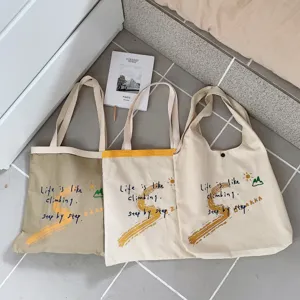 Canvas tote bag large capacity casual shoulder bag with letter print stylish daily carry.