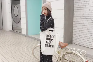 Casual canvas tote bag with letter print detail, spacious shoulder bag for daily use.