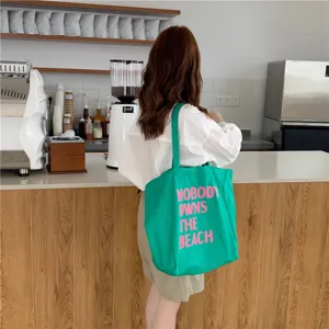 Green canvas tote bag for women, large capacity shoulder shopping bag with pink letter print.