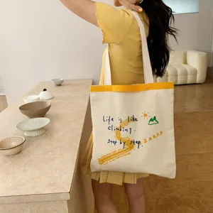 Canvas tote bag with large capacity, stylish letter print, casual shoulder bag for daily use.