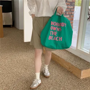 Green canvas tote bag with pink letter print, casual large capacity shoulder shopping bag for women.
