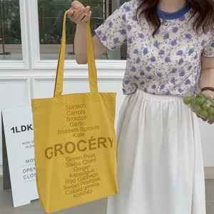 Yellow canvas tote bag with grocery letter print, casual shoulder bag for daily use.