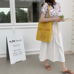 Yellow canvas tote bag with grocery letter print, casual single shoulder bag for women.