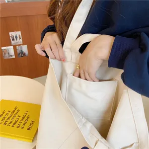 Canvas tote bag detail view showing interior pocket and durable cotton material construction.