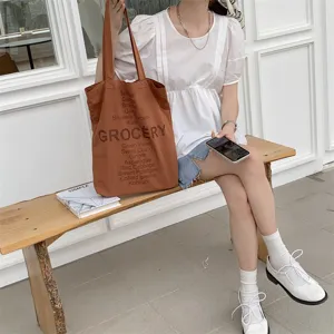 Brown canvas tote bag for women, casual letter print grocery shoulder handbag detail.