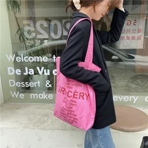 Stylish pink canvas tote bag for women, casual grocery print shoulder bag with spacious design.
