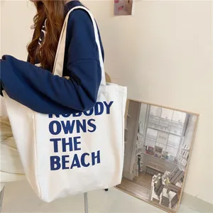 Detailed shot of the minimalist canvas shoulder bag featuring stylish letter print, spacious interior.