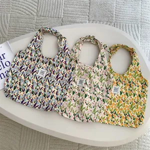 Floral print canvas tote bag detail view, casual shoulder shopping handbag close-up display.