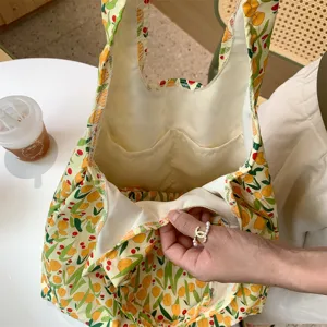 Detailed view of the cute floral canvas tote bag, showing interior pockets and fine lining.