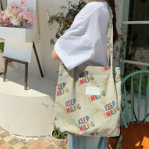 Corduroy tote bag with smiling print, large capacity shoulder bag for women daily commute.