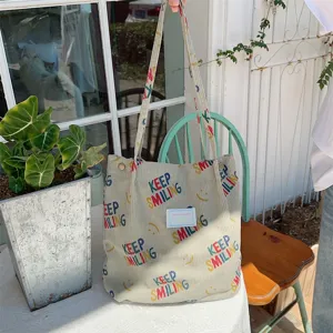 Casual corduroy tote bag for women, large capacity shoulder bag with letter print and smile faces.