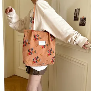 Casual corduroy tote bag with cute smiling print, large capacity shoulder bag for daily use.