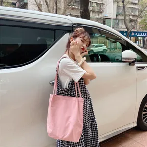 Pink canvas shoulder bag detail view, casual tote style for everyday use and street wear.