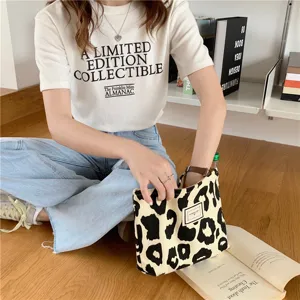 Detailed view of large capacity leopard print canvas tote bag, casual shoulder bag for women.