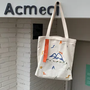 Sac cabas en toile avec broderie colorée et sangle contrastée, grande capacité décontractée.