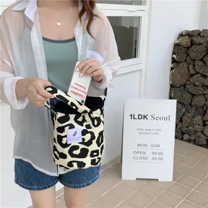 Leopard canvas bucket bag detail, casual shoulder tote handbag with cute animal print pattern.