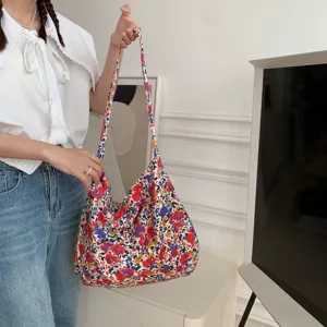 Detailed view of the vibrant floral canvas shoulder bag, showcasing large capacity and durable strap.
