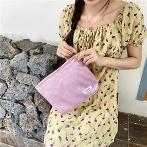 Detail view of the purple corduroy makeup pouch, showing soft texture and compact design.