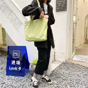 Casual light green canvas tote shoulder bag for women, stylish and minimalist daily design.