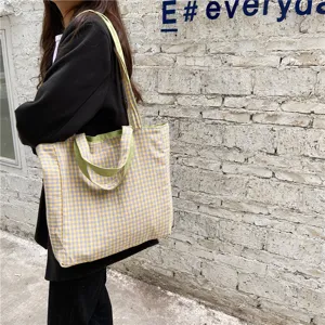 Detail view of a casual Japanese style plaid canvas shoulder bag in yellow and purple.