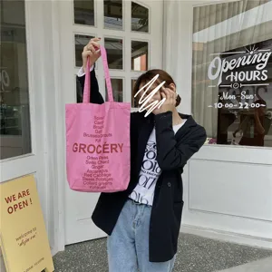 Pink canvas tote shoulder bag with letter print, casual grocery bag for daily use.