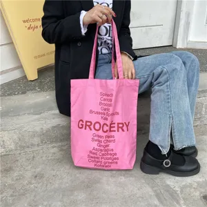 Pink canvas tote bag with grocery letter print, stylish casual shoulder bag for women.
