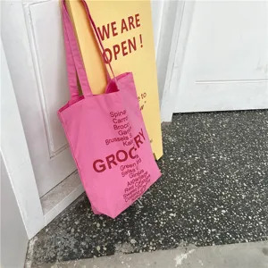 Pink canvas tote bag with grocery letter print, casual single shoulder bag for students daily use.