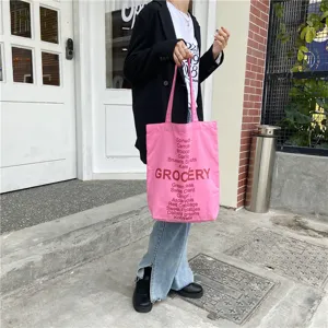 Pink canvas grocery tote bag with stylish letter print, casual shoulder bag for women daily use.