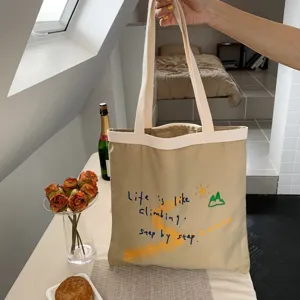 Casual canvas tote bag with inspiring letter print, large capacity shoulder bag for daily use.
