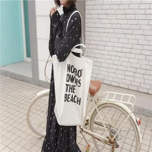 Casual minimalist canvas tote bag with stylish letter print, spacious design for daily use.